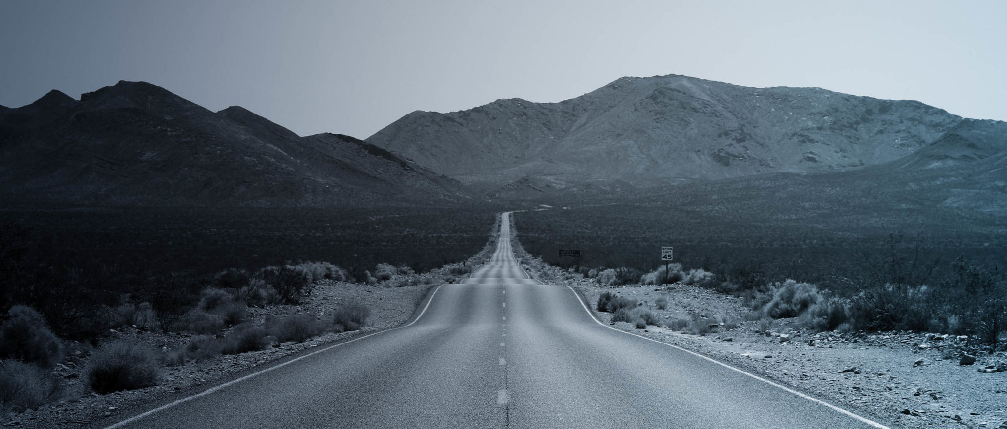 empty rural highway with moutains