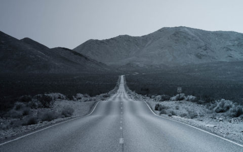 empty rural highway with moutains