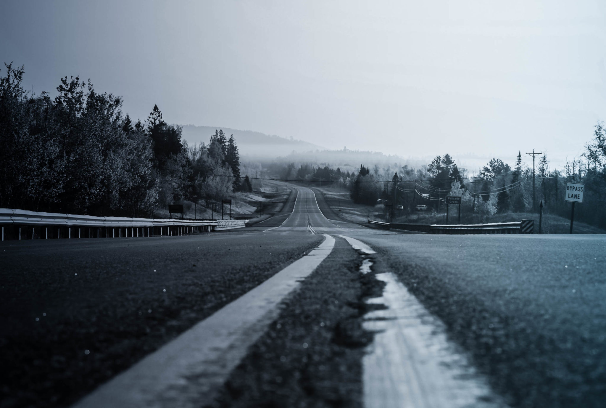 empty rural highway with hills in the distance