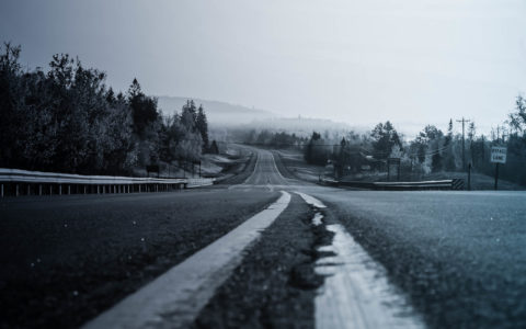 empty rural highway with hills in the distance